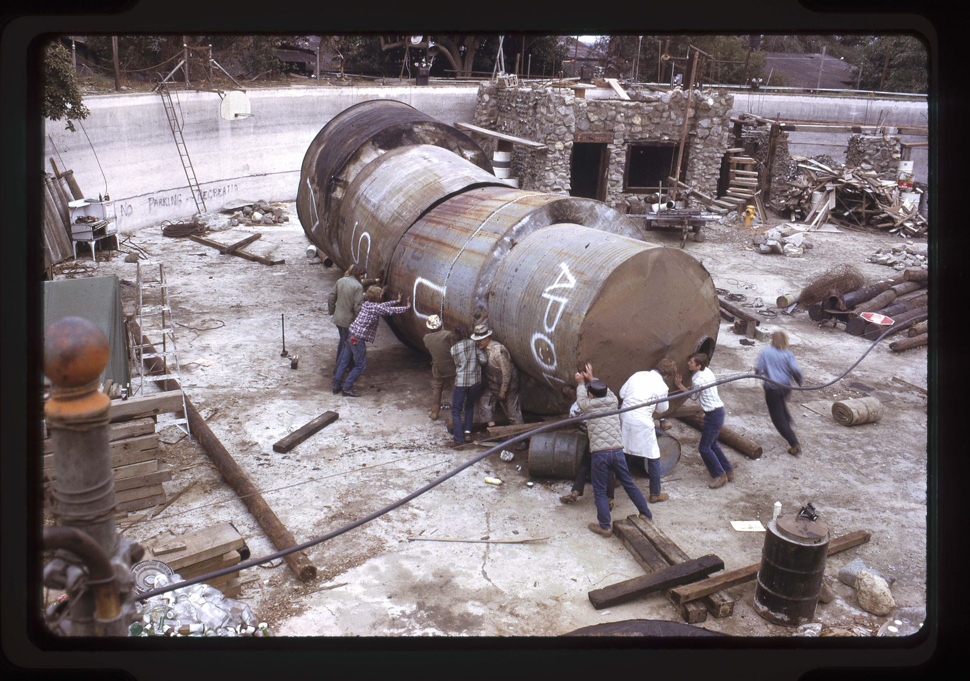 Clock Tower tank core being assembled, ca. 1976 35mm slides (photographs), Hunn-c2019-2-10-005~016, Three out of four water tanks scavenged from local farms make up the core of the Clock Tower are assembled, once completed with all four tanks it was lifted into vertical position, 